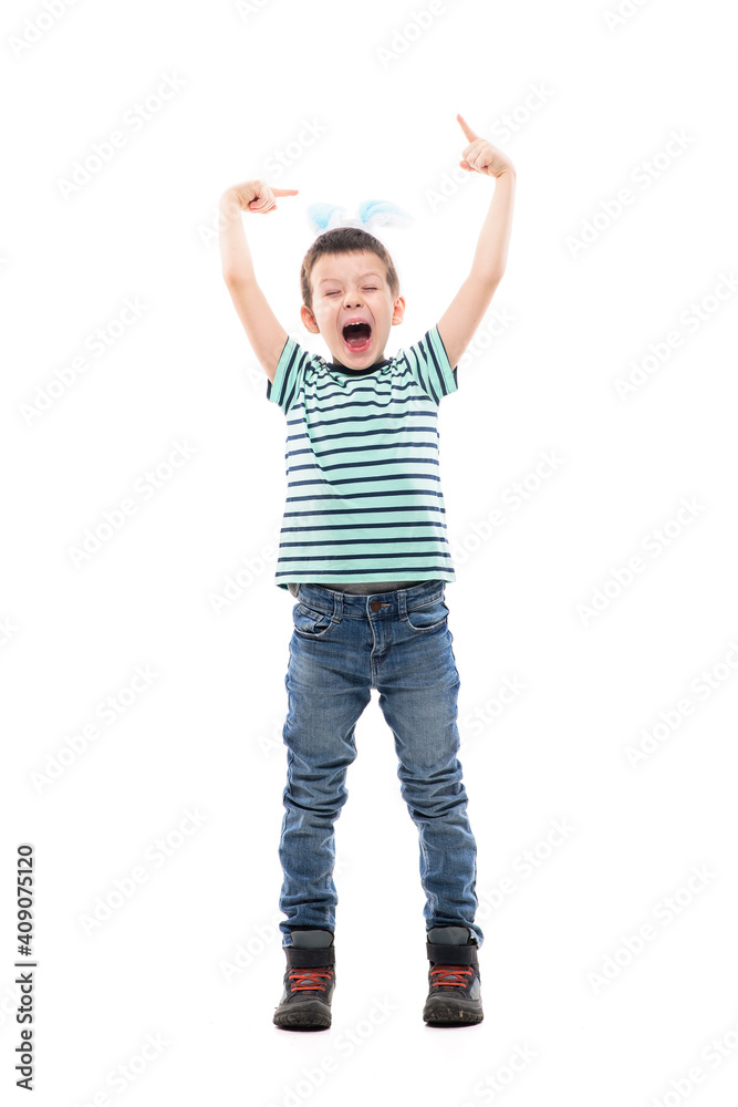Cheerful excited young kid with Easter bunny ears pointing up and screaming. Full length isolated on white background. Cheerful excited young kid with Easter bunny ears pointing up and screaming. Full length isolated on white background.