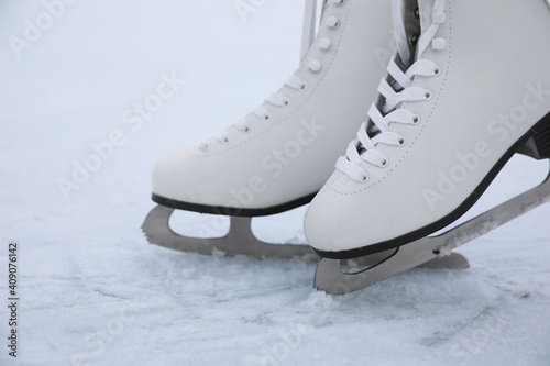 Figure skates with laces on ice. Winter outdoors activities