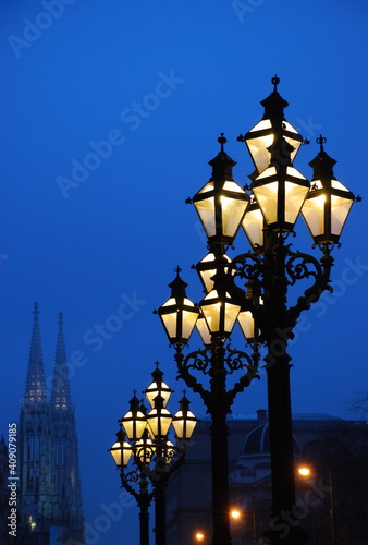 Lighted street lamps against blue sky in the evening in Vienna