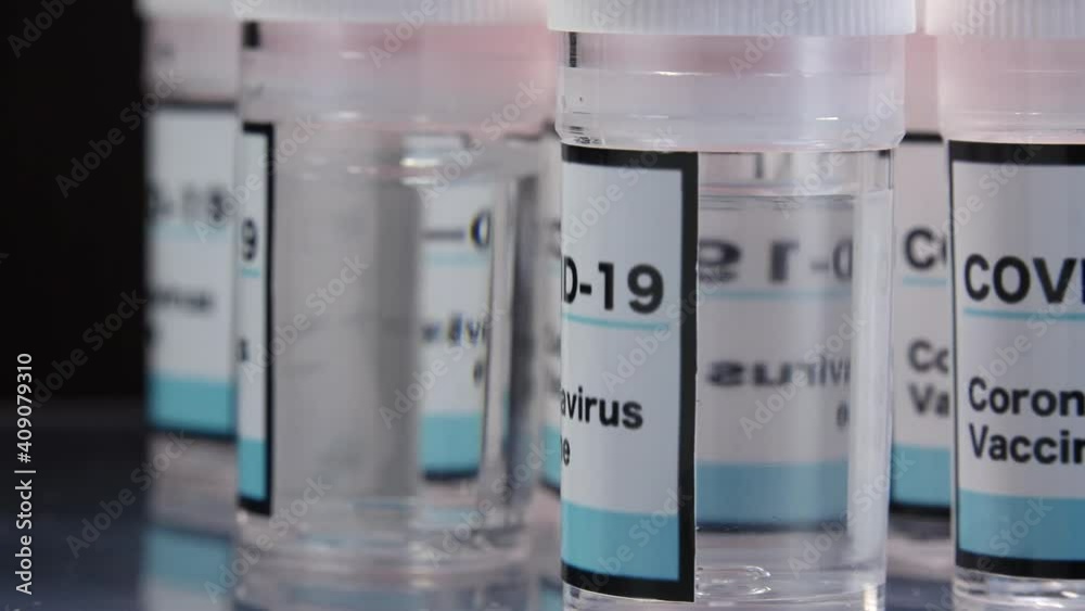 CORONAVIRUS (COVID-19) VACCINE. Blue glass bottle of liquid remedy for injection use. Manufacture drugs for medical supplies of pharmacy industry. Sterile production of pharmaceutical medication. CORONAVIRUS (COVID-19) VACCINE. Blue glass bottle of liquid remedy for injection use. Manufacture drugs for medical supplies of pharmacy industry. Sterile production of pharmaceutical medication.