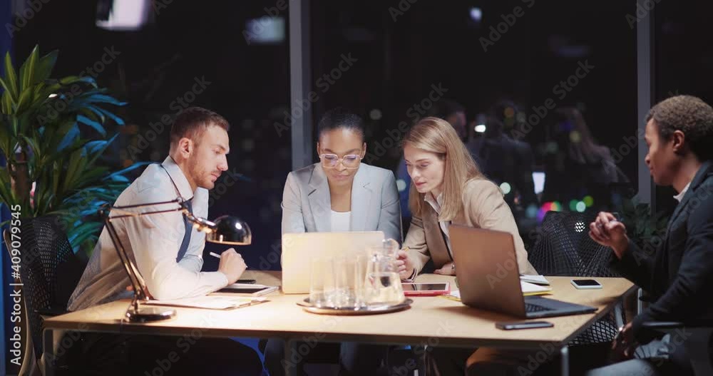 Late night office executives gathering in boardroom to discuss creative ideas and develioment strategy. Teambuilding. Corporate teamwork. Late night office executives gathering in boardroom to discuss creative ideas and develioment strategy. Teambuilding. Corporate teamwork.