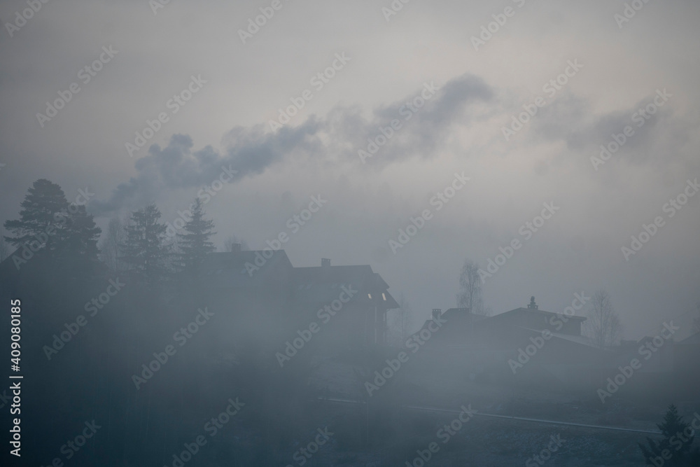 Cozy House in Mountains at Foggy Morning. Misty landscape in the mountains. Fantastic morning Twilight