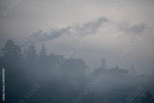 Cozy House in Mountains at Foggy Morning. Misty landscape in the mountains. Fantastic morning Twilight