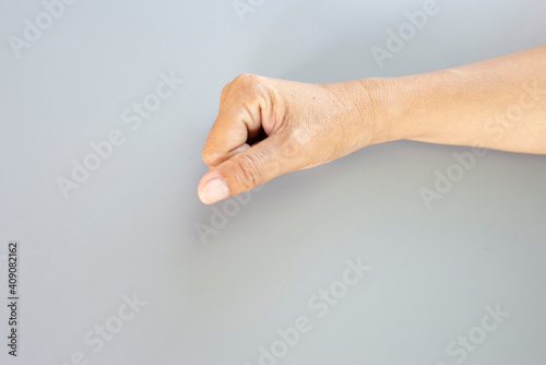 Old man hand and finger gesture with empty gray background