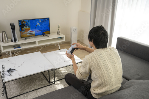 Young Asian guys enjoying video games / Asian guys crazy about games / Black-haired guys playing games  photo