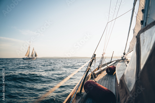 A schooner in Maine Bay viewed from another sailboat during late day photo