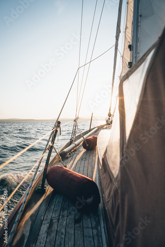 The deck of a sailboat sailing in Maine during late day