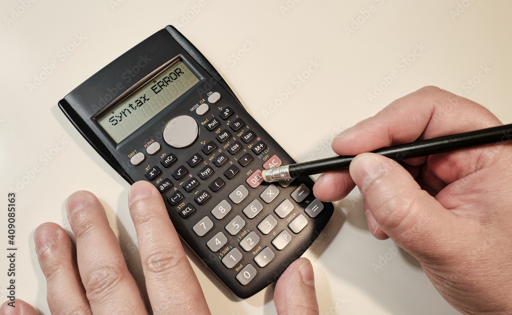 Man using scientific calculator at white table Man using scientific calculator at white table