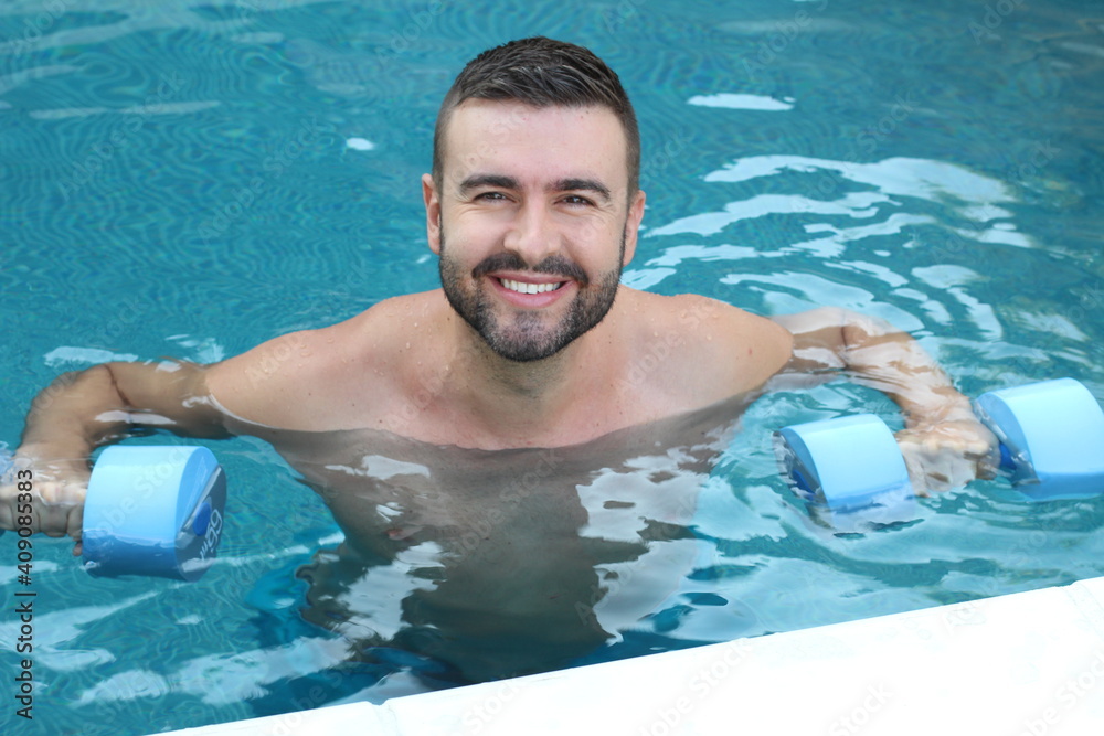 Young man exercising in swimming pool