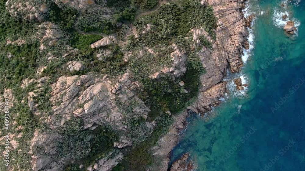 Drone hovers over a beautiful coast between nature and blue water Drone hovers over a beautiful coast between nature and blue water