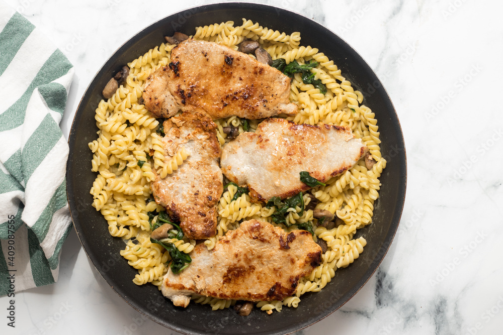 Freshly cooked meat with spinach pasta in baking pan, top view Freshly cooked meat with spinach pasta in baking pan, top view