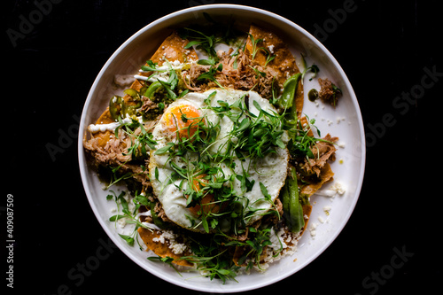 Above-view of Mexican huevos rancheros on dark background photo