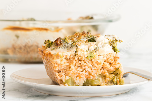 Broccoli rice casserole served for one on a white plate