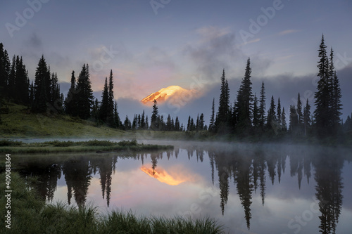 Mount Rainier peeking through the clouds during early morning sunrise