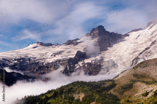 Snow and clouds accentuate the mountain textures of crevices and peaks