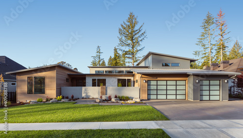 Contemporary luxury home exterior in late afternoon photo