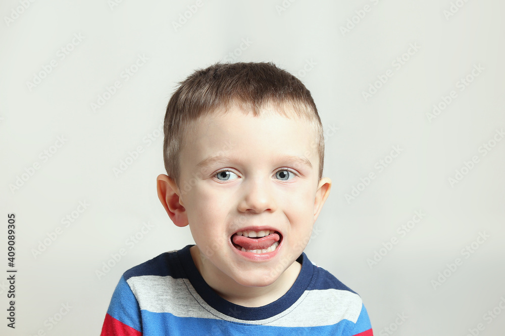 Boy, kid performs articulation exercises for the tongue, correct pronunciation, vocals, dental concept, speech therapy