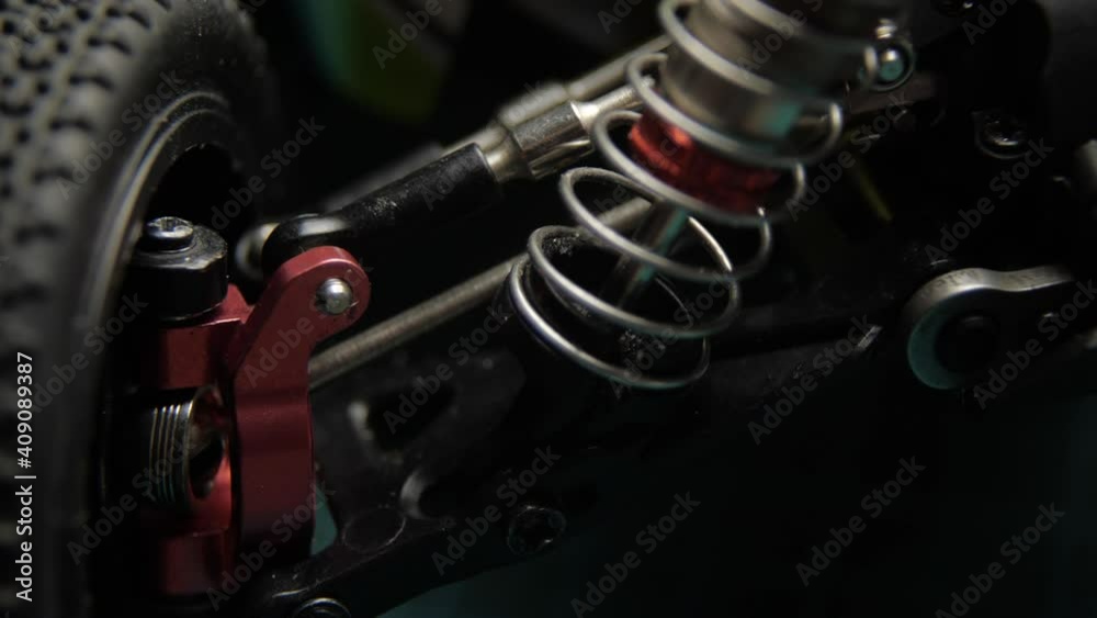 Close-up of radio control model suspension elements buggy car on cutting mat Close-up of radio control model suspension elements buggy car on cutting mat