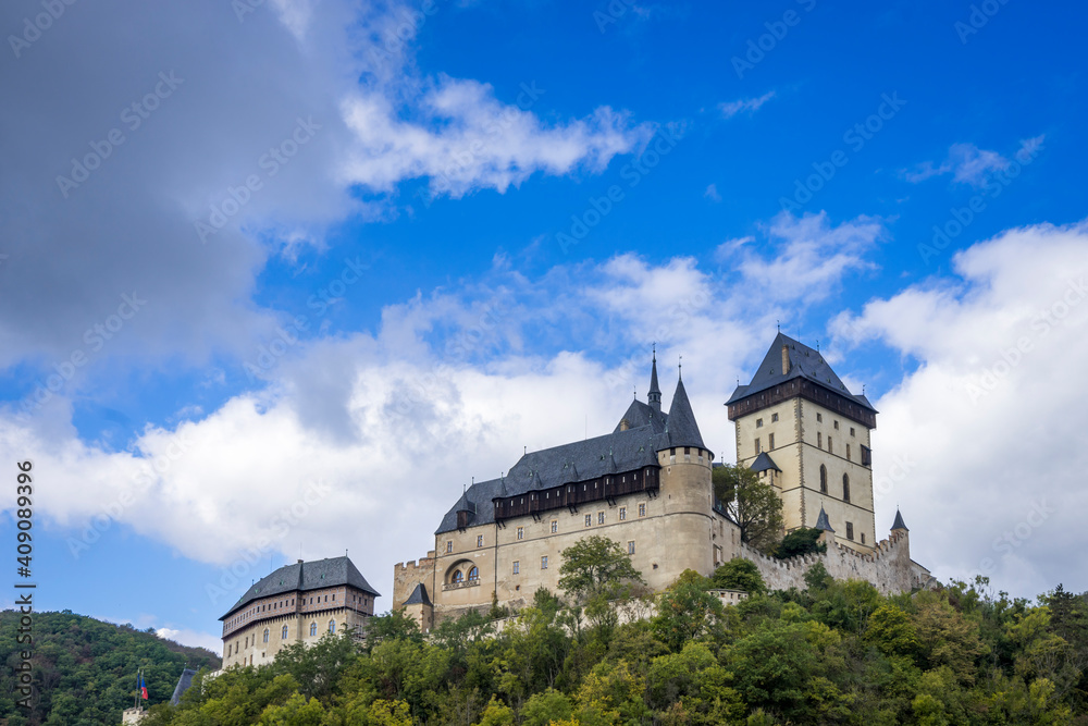 Low angle view of Karlstejn Castle against sky on sunny day, Karlstejn, Beroun District, Central Bohemian Region, Czech Republic Low angle view of Karlstejn Castle against sky on sunny day, Karlstejn, Beroun District, Central Bohemian Region, Czech Republic