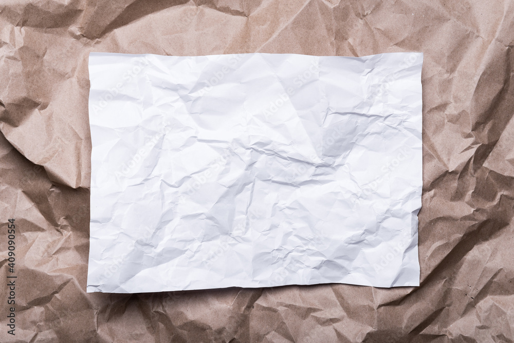 Obraz premium crumpled cream craft paper like a frame, and white paper, background texture