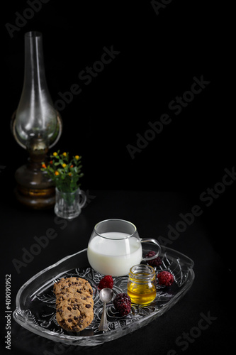 Chocolate Chip Cookies and milk on dark