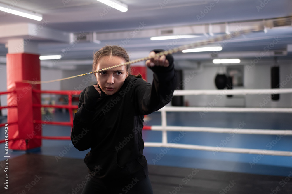 Strong woman doing shadow boxing on ring Strong woman doing shadow boxing on ring