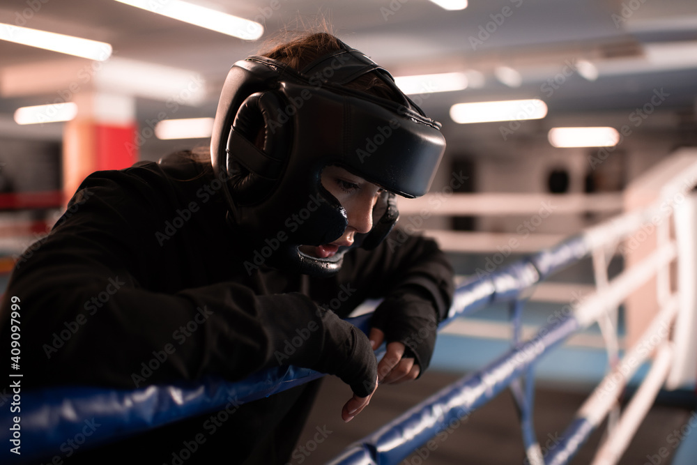 Tired female boxer resting after fight Tired female boxer resting after fight