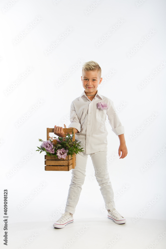 Studio portrait of fashionable blond caucasian boy with wooden basket of flowers, white background, copy space Studio portrait of fashionable blond caucasian boy with wooden basket of flowers, white background, copy space