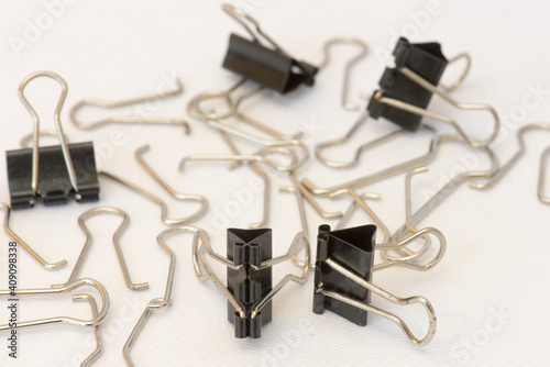 Closeup of several paper clips in different positions and arranged randomly.