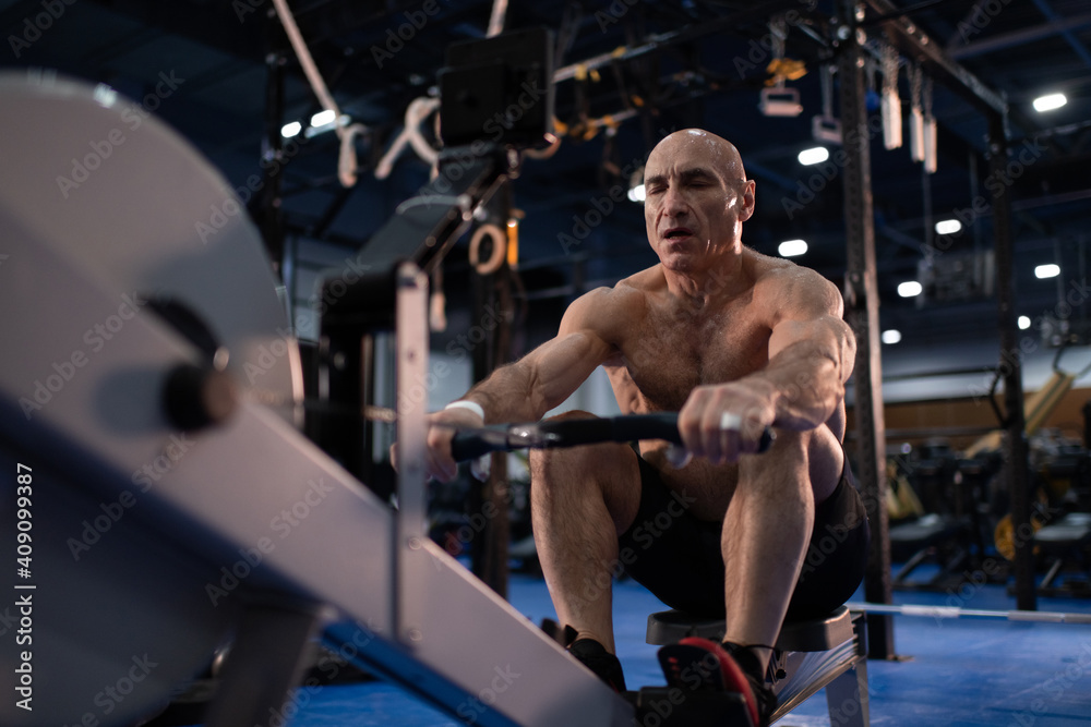Elderly male athlete exercising with closed eyes Elderly male athlete exercising with closed eyes