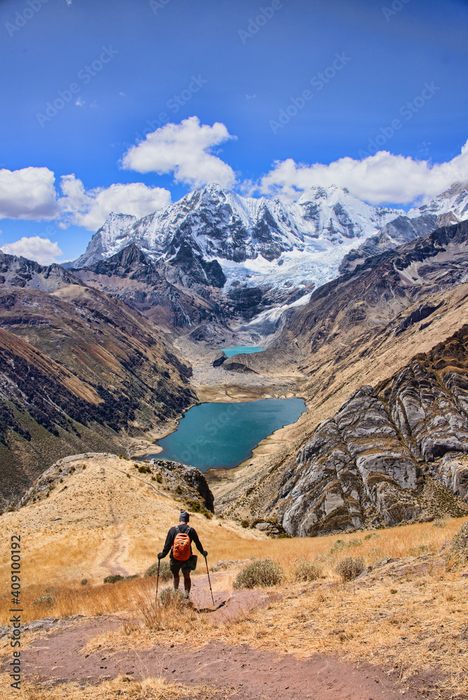 A trekker descending down to Laguna Jahuacocha and the entire Cordillera Huayhuash, Ancash, Peru. A trekker descending down to Laguna Jahuacocha and the entire Cordillera Huayhuash, Ancash, Peru.