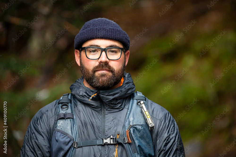 Portrait of an outdoor traveling bearded man with glasses and hat Portrait of an outdoor traveling bearded man with glasses and hat