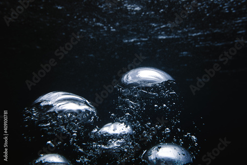 Big bubbles break the blue surface photo