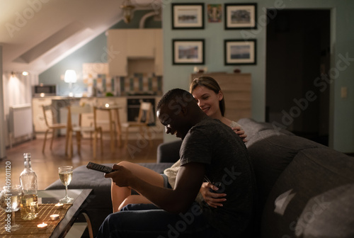 Excited diverse couple watching TV