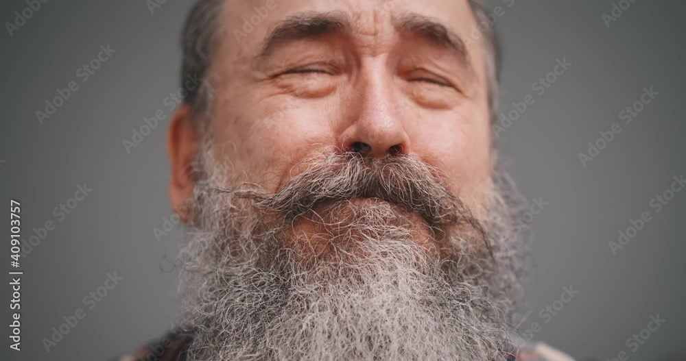 Close up portrait of senior man crying isolated on gray background Close up portrait of senior man crying isolated on gray background