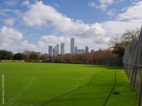 Austin skyline across green ball field