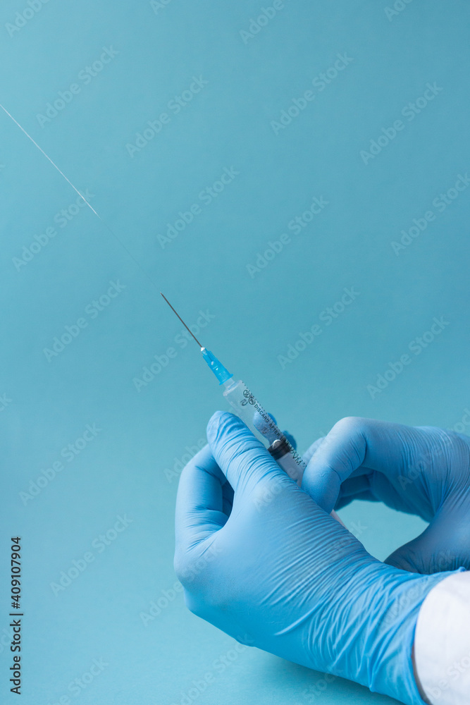 Syringe close up in doctor's hands, nurse vaccinating, covid 19 or coronavirus vaccine Syringe close up in doctor's hands, nurse vaccinating, covid 19 or coronavirus vaccine