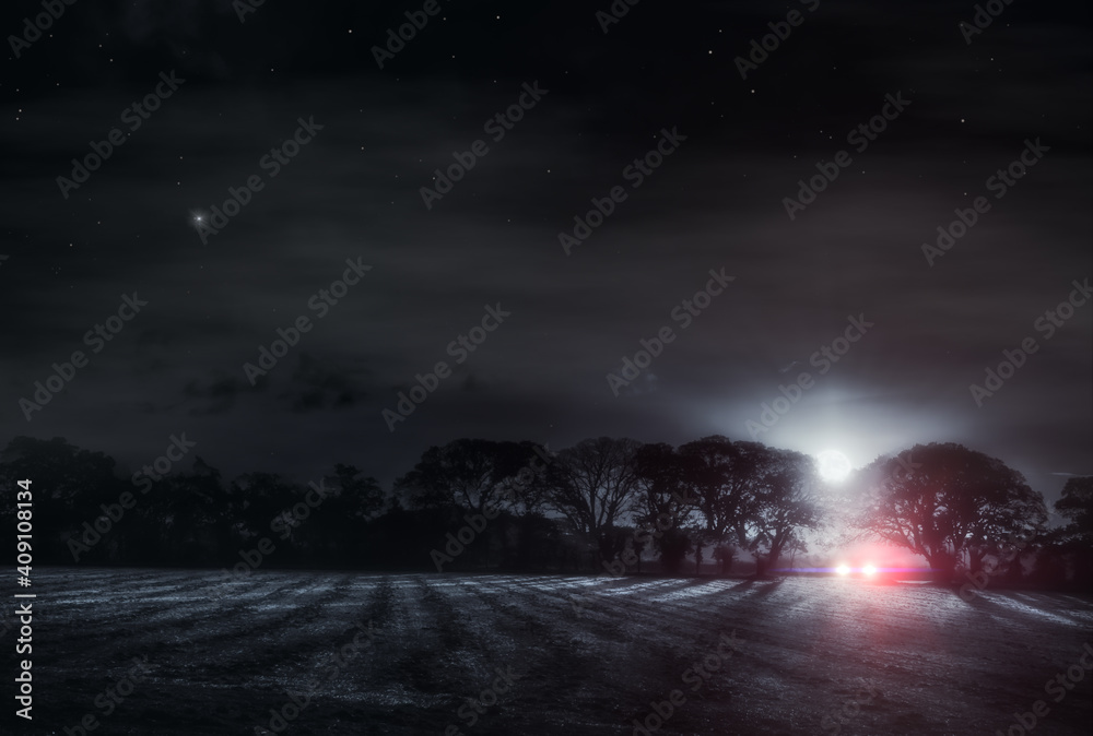 Fototapeta premium Lone driver in a dark field