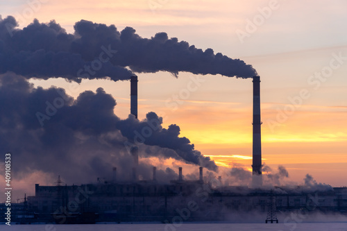 Emission to atmosphere from industrial pipes. Smokestack pipes shooted at sunrise. Global warming concept and air pollution photo