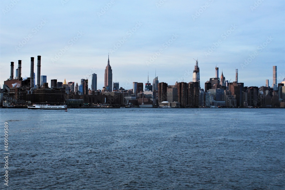New york skyline, USA - 20.12.2019: Williamsburg bridge in New York Manhattan skyline skyscrapers behind at sunset - stock photo