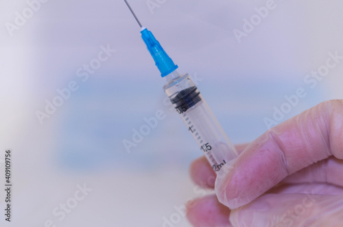 Human Hand with injection Syringe, on white background.