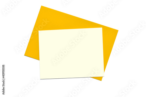 Blank card on yellow envelope. Minimalist composition on white background. Top view, empty space for text. 