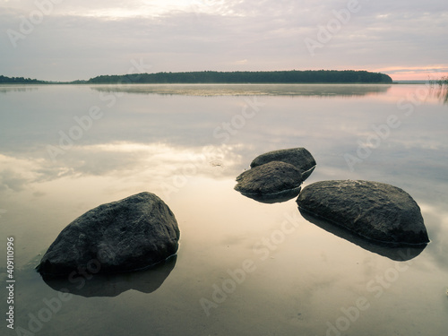 Stones in the lake water. Seksty lake on Masuria, Poland.
