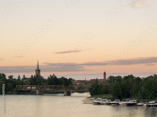 Mikołajki, Masuria, Poland, 30. July 2020. Railway bridge and mikolajki churche towers. Talty lake. © Pawel S