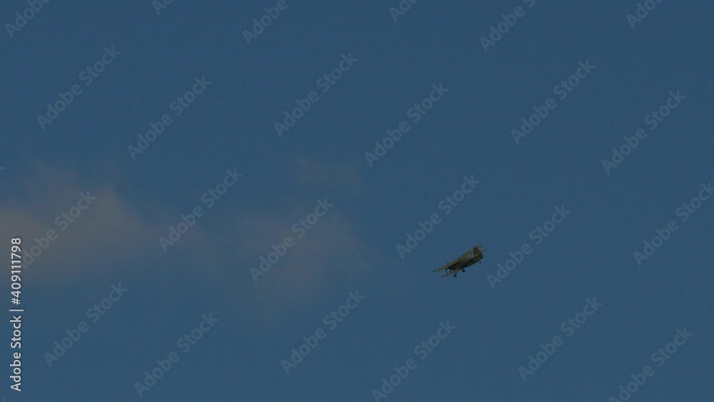 Light single-engine biplane An-2 unfolds in the blue sky..A voyage on a vintage light single-engine airplane. Light single-engine biplane An-2 unfolds in the blue sky..A voyage on a vintage light single-engine airplane.