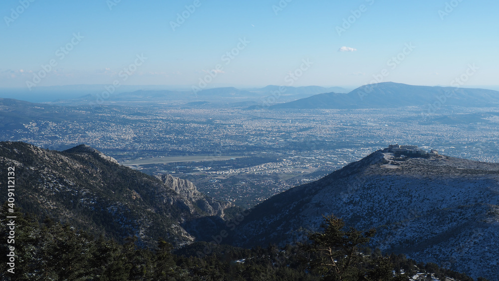 Breathtaking scenic view to whole Athens - Attica from snowed peak of Parnitha mountain, Greece