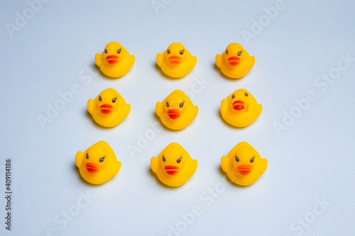 Rubber yellow ducks on a blue background . Rubber toys for the water. Children's toys. Ducks of the Kopi space. Blue background. An article about playing in the water.