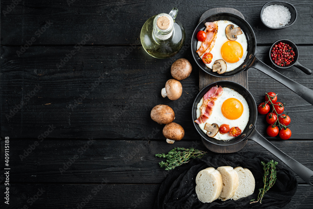 Fried Egg with ingredients in cast iron frying pan, on black wooden table background, top view flat lay , with space for text  copyspace
