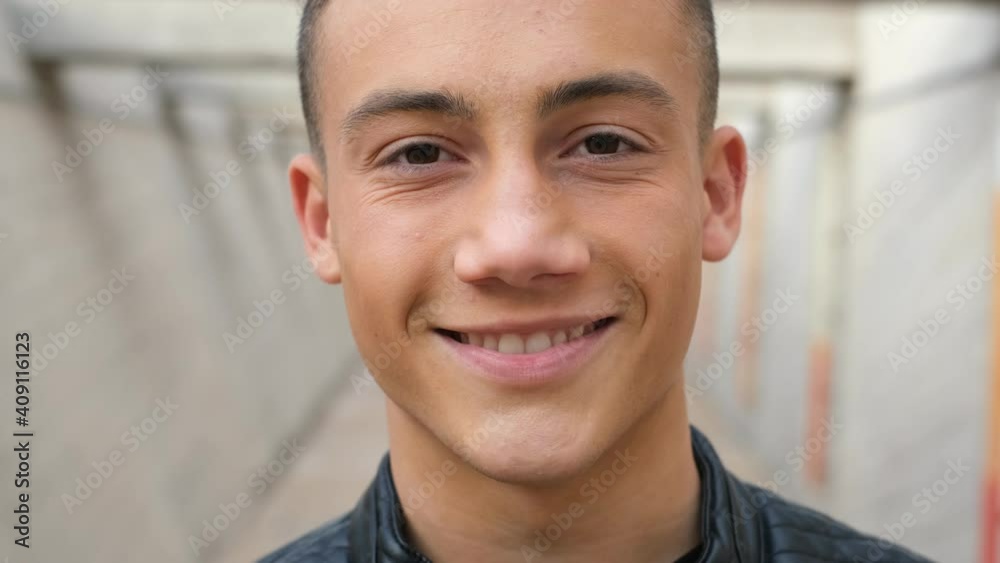 Close up of one young man smiling and laughing looking at the camera having fun. Portrait of teenager opening eyes feeling good.
Close up of one young man smiling and laughing looking at the camera having fun. Portrait of teenager opening eyes feeling good.