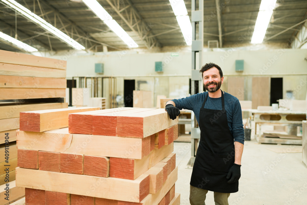 Portrait of a handsome carpenter working in a wood workshop Portrait of a handsome carpenter working in a wood workshop